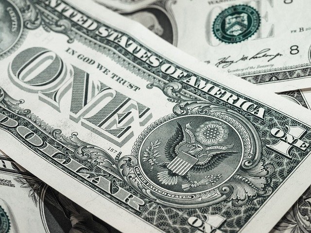 A dollar bill representing the financial conversations couples explore in the SYMBIS assessment
